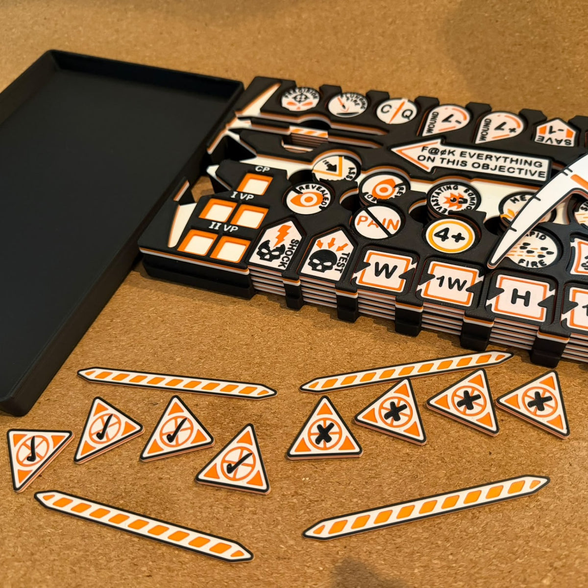 mw-382-box-open: loaded travel box beside its dice-tray lid, with deployment markers and operation markers