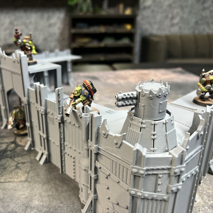 Scrap Fort corner bastion tower with jagged crown beside riveted scrap-metal wall sections