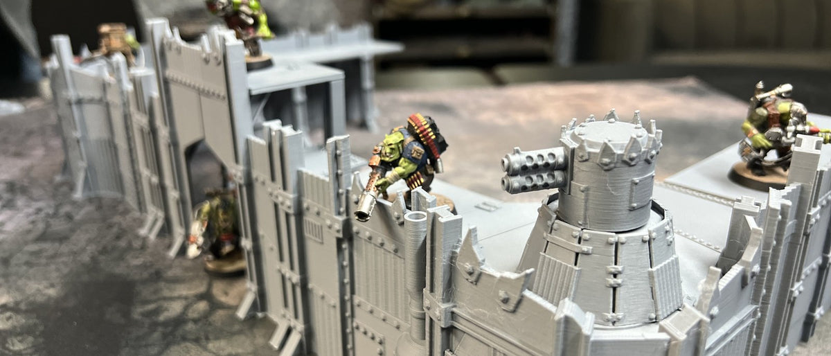 Scrap Wasteland terrain on a wargaming table with painted orc miniatures